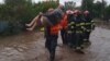 Emergency workers evacuate a resident of Glati county in Romania's eastern Moldova region on September 13.