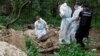Forensic experts exhume the bodies of seven people near the village of Vorzel in the Kyiv region on June 13. According to police, they were all killed by shots to the head. Some of them had their hands tied.
