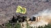 Lebanon/Isreael -- Israeli soldiers waving Hizballah flag on a top of an APC crossing from the Lebanese side of the border return to Israel after a battle in Lebanon near the village of Avivim, 27Jul2006