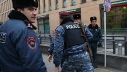 Armenia -- Armed policemen rush to Erebuni Plaza Business Center where a gunman opened fire, Yerevan, January 23, 2020.
