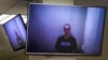 Russian opposition leader Aleksei Navalny appears on TV screens via a video link from prison during a court hearing in Moscow on April 29.