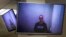 Russian opposition leader Aleksei Navalny appears on TV screens via a video link from prison during a court hearing in Moscow on April 29.