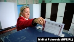 A voter casts her ballot in Sarajevo.