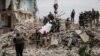 Rescuers remove a body from a residential building damaged by a Russian military strike in the town of Chasiv Yar on July 10.