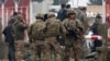 U.S. troops stand guard at the site of a suicide attack in Kabul on February 20.