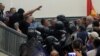 More than 200 protesters, some wearing masks, stormed the building after the new majority in the legislature had elected an ethnic Albanian as speaker, paving the way for the formation of a government led by the Social Democrats. 