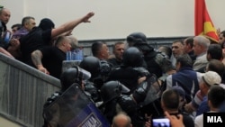 More than 200 protesters, some wearing masks, stormed the building after the new majority in the legislature had elected an ethnic Albanian as speaker, paving the way for the formation of a government led by the Social Democrats. 