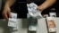 Russia -- An employee of a bank counts rouble banknotes in Moscow September 2, 2014. 