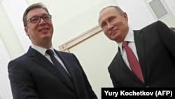 Russian President Vladimir Putin (right) meets with Serbian President Aleksandar Vucic at the Kremlin in Moscow on December 19.
