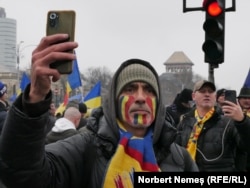 Protestatar în Piața Victoriei miting împotriva Guvernului Ciolacu din România.