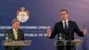 Serbian President Aleksandar Vucic (right) speaks at a press conference after talks with EU Enlargement Commissioner Johannes Hahn (left) in Belgrade on February 7.