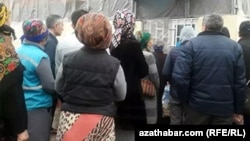 Adamlar döwlet dükanynyň öňünde çörek satyn almak üçin, nobata garaşyp durlar.