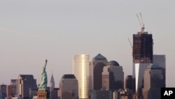 U.S. -- The Statue of Liberty (L) and One World Trade Center (R) frame the New York skyline, 23Aug2011