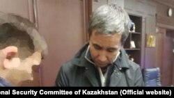 Токмадини кармоо учурунда тартылган видеотасмадан алынган сүрөт.