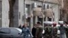 Armenia -- Security forces prepare to search the State Revenue Committee building after what turned out to be a false bomb alert on February 25, 2010. 
