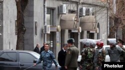 Armenia -- Security forces prepare to search the State Revenue Committee building after what turned out to be a false bomb alert on February 25, 2010. 