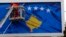 A worker fixes the national flag of Kosovo to a billboard ahead of Kosovo's fifth anniversary of its independence in Pristina in February 2013.