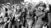 UK --  happy group marches down a London street on VE Day.