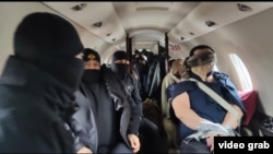 Turkey - A screenshot from video of Turkish policemen escorting two men extradited by Armenia, January 19, 2025.