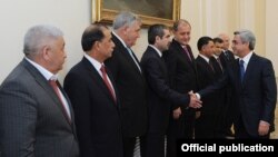 Armenian President Serzh Sarkisian greets Azerbaijani Interior Minister Ramil Usubov (third from right) and police chiefs from other former Soviet republics who met in Yerevan on October 14.