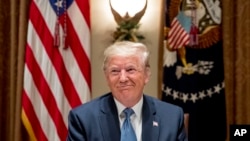 President Donald Trump smiles during a luncheon with members of the United Nations Security Council in the Cabinet Room at the White House in Washington, Thursday, Dec. 5, 2019. (AP Photo/Andrew Harnik)