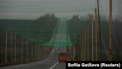 Автоунаа дрондордон коргоо үчүн тор менен жабылган жолдо баратат, Донецк облусунун Славянск шаарына жакын жер, Украина, 27-октябрь, 2025-жыл.