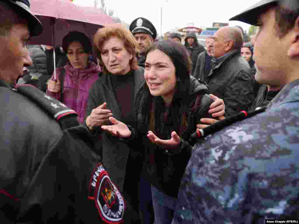 On a rainy, cold morning in Yerevan, protesters try to reason with police.