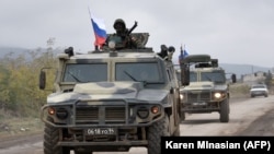NAGORNO-KARABAKH -- Armored vehicles of Russian peacekeepers move along the road towards Agdam from their check point outside Askeran, November 20, 2020.