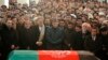 Afghan President Hamid Karzai (center) prays near the flag-draped coffin of Afghan Vice President Marshal Mohammad Qasim Fahim during his burial ceremony at the Presidential Palace in Kabul on March 11.