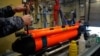 Ukrainian Navy sailors prepare a SeaFox drone on the Cherkasy minehunter ship during exercises in the United Kingdom on February 19.