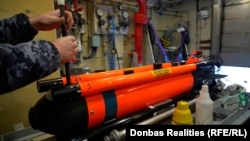 Ukrainian Navy sailors prepare a SeaFox drone on the Cherkasy minehunter ship during exercises in the United Kingdom on February 19.