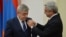 Armenia -- President Serzh Sarkisian awards a medal to his brother Levon, March 22, 2016.