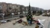 Municipal workers set up a Christmas tree on a square in Mariupol, in the Russian-controlled Donetsk region of eastern Ukraine, on December 24.