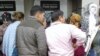 Turkmen migrants stand in line in front of an ATM in Istanbul, Turkey. 