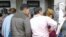 Turkmen migrants stand in line in front of an ATM in Istanbul, Turkey. 