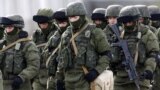 UKRAINE – Uniformed men, believed to be Russian servicemen, walk in formation near a Ukrainian military base in the village of Perevalnoye outside Simferopol, March 6, 2014