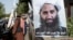 Poster of Taliban spiritual leader Haibatullah Akhundzada along a road in Kabul.