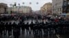 Russian law enforcement officers block a road as protesters march during a rally in support of jailed Russian opposition leader Alexei Navalny in St. Petersburg on January 23. 