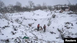 Halas edijiler 8-nji ýanwarda Ukrainanyň Donetsk sebitindäki Pokrowsk şäherçesinde rus raketasynyň düşen ýerinde iş alyp barýar. 