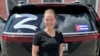 In an undated social media image, Yelena Smirnova, a travel agent from Ryazan, is seen in front of a car showing a Cuban flag and the letter "Z"-- a symbol for Russia's war on Ukraine.