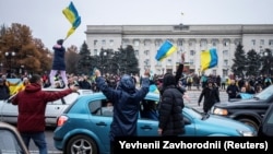 People celebrate the liberation of Kherson from Russian occupation on November 12. 