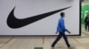 People walk past a closed store of Nike in St. Petersburg on May 25.