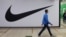 People walk past a closed store of Nike in St. Petersburg on May 25.