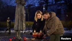 Ukrainian President Volodymyr Zelenskiy and his wife, Olena, visit a monument to Holodomor victims in Kyiv in November 2022.