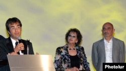 Armenia -- Canadian-Armenian director Atom Egoyan (L) and Italian actress Claudia Cardinale open the annual Golden Apricot film festival in Yerevan, 11July 2010.