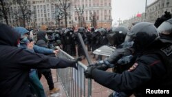 Law enforcement officers clash with participants during a rally in support of jailed Russian opposition leader Aleksei Navalny in Moscow on January 23.