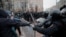 Law enforcement officers clash with participants during a rally in support of jailed Russian opposition leader Aleksei Navalny in Moscow on January 23.