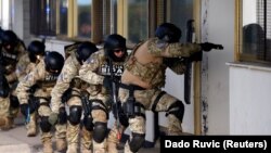 Bosnian State Investigation and Protection Agency agents practice a counterterrorism situation during an exercise at Sarajevo's airport.