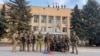 Ukrainian soldiers pose in front of the Lyman administration office on October 1.