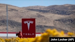 The U.S. Justice Department says Yegor Kryuchkov offered a Tesla employee $1 million to install malicious software to get access to the firm's networks as part of an extortion scheme.